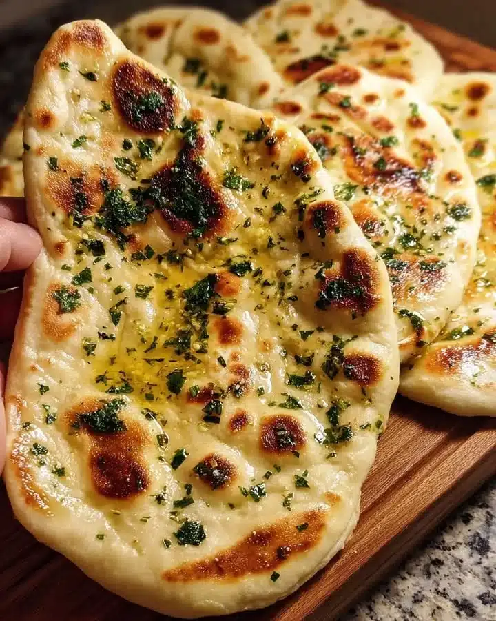Delicious homemade naan bread served warm with curries and dips