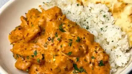 Delicious plate of dreamy creamy butter chicken served with rice and naan.