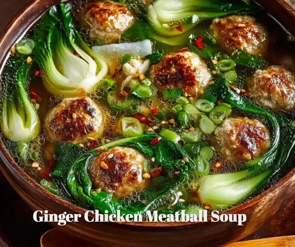 Bowl of delicious Ginger Chicken Meatball Soup garnished with fresh herbs