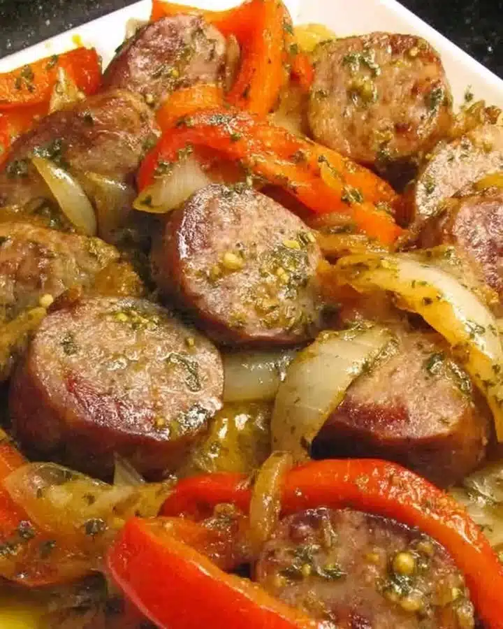 Delicious Italian sausage with colorful peppers and onions on a plate
