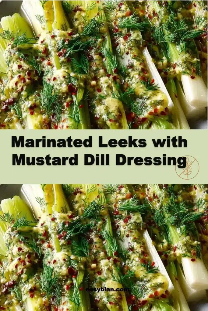 Marinated leeks served with mustard dill dressing on a plate