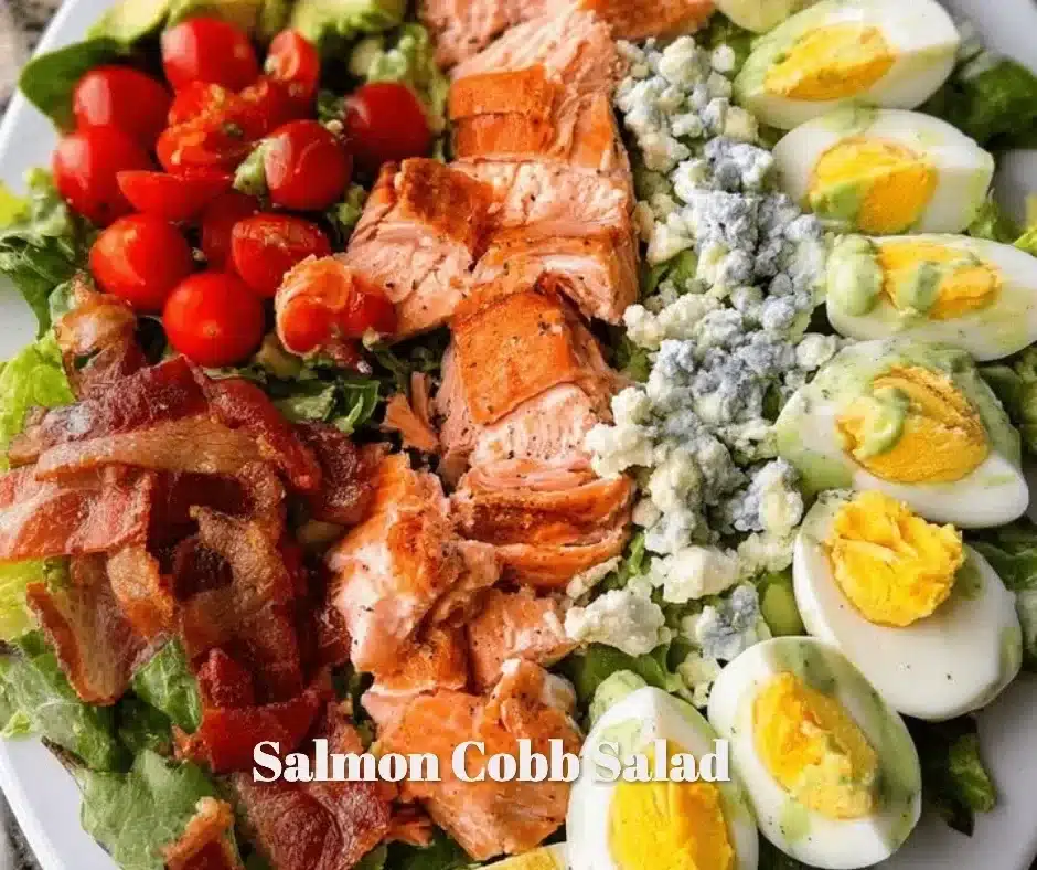 A vibrant Salmon Cobb Salad with fresh greens, topped with salmon, avocado, and eggs.