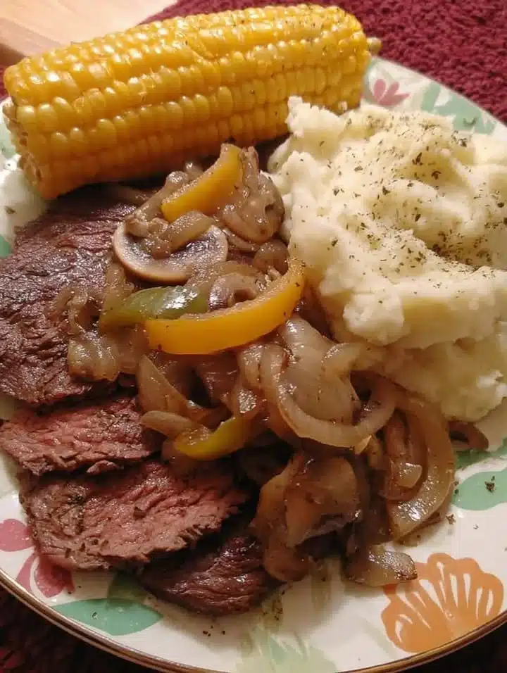 Steak with Onion & Pepper Gravy 1 Steak served with onion and pepper gravy on a plate