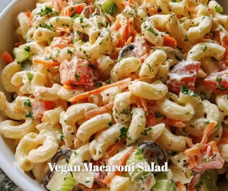 Bowl of colorful vegan macaroni salad with fresh vegetables