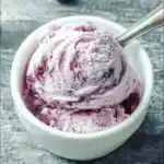 Keto Blueberry Cheesecake Ice Cream served in a bowl with blueberries on top