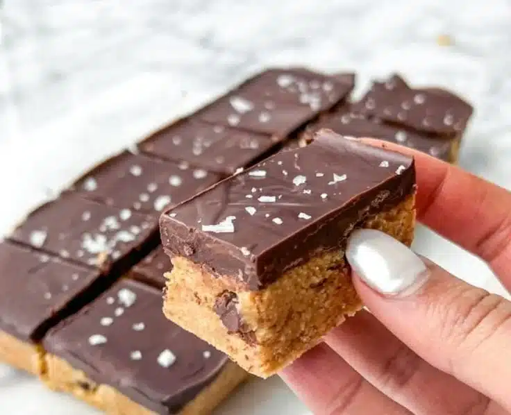 Delicious no bake cookie dough bars topped with chocolate chips and nuts