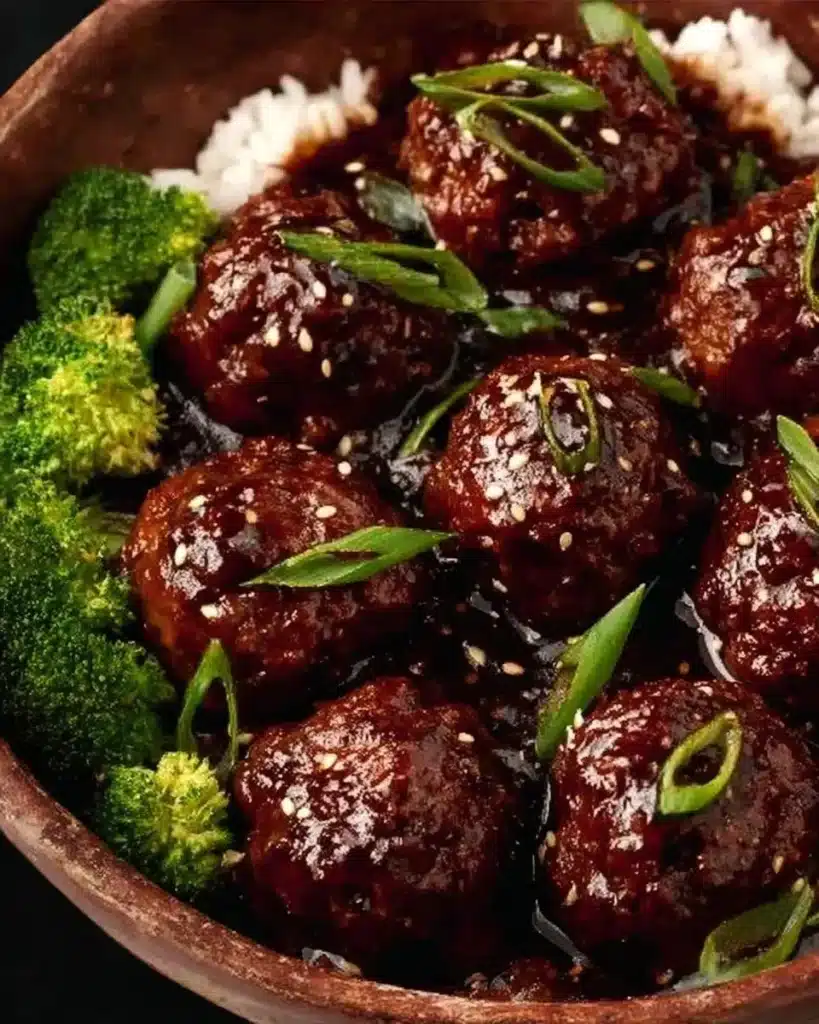 Sticky Mongolian Beef Meatballs served on a plate with garnishes.
