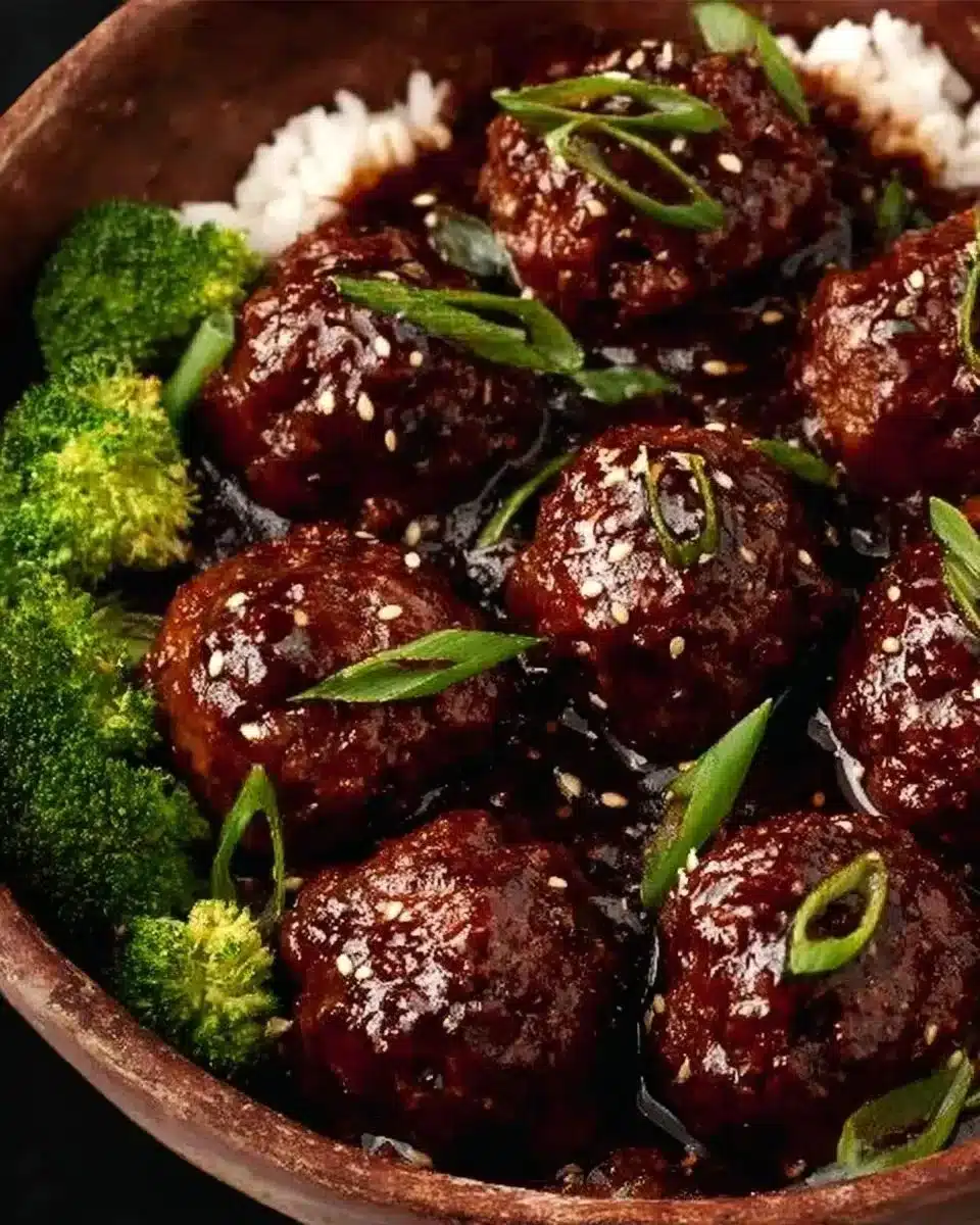 Sticky Mongolian Beef Meatballs 1 Sticky Mongolian Beef Meatballs served on a plate with garnishes.