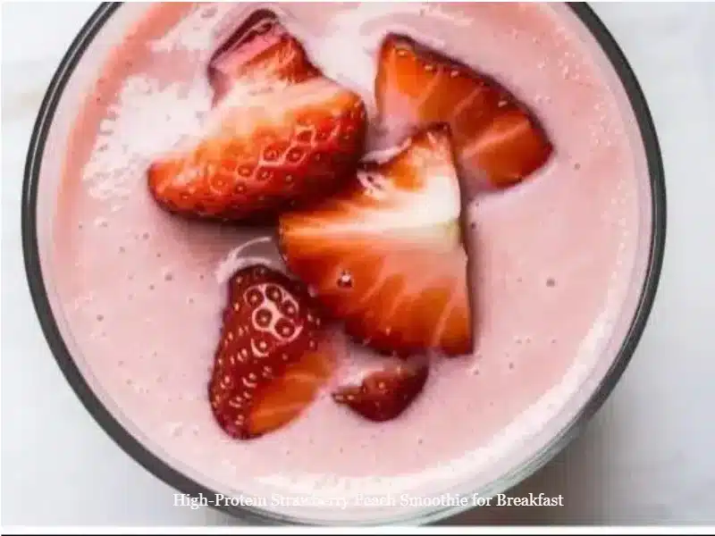 High-protein strawberry peach smoothie in a glass with fruits