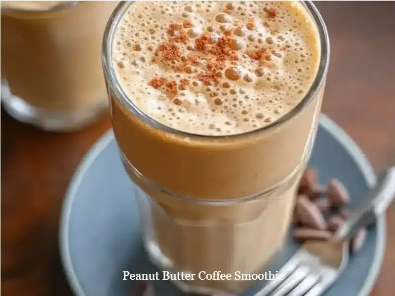 Delicious Peanut Butter Coffee Smoothie in a glass, topped with cocoa powder.