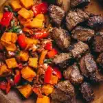Whole30 steak bites with sweet potatoes and bell peppers served on a plate