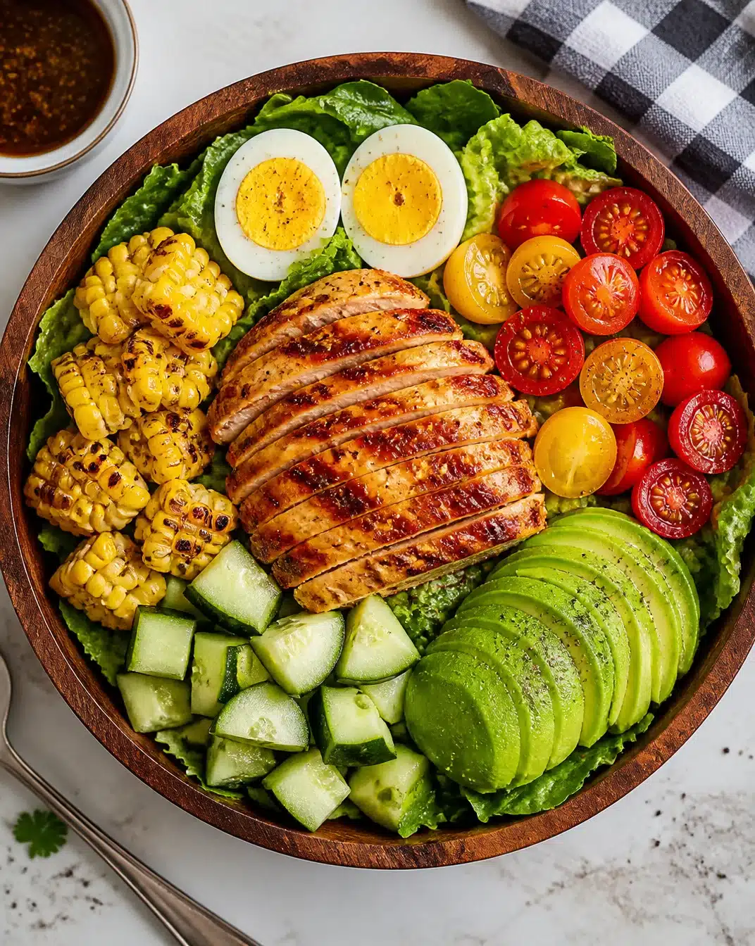 Citrus-glazed grilled chicken salad with fresh greens and colorful vegetables