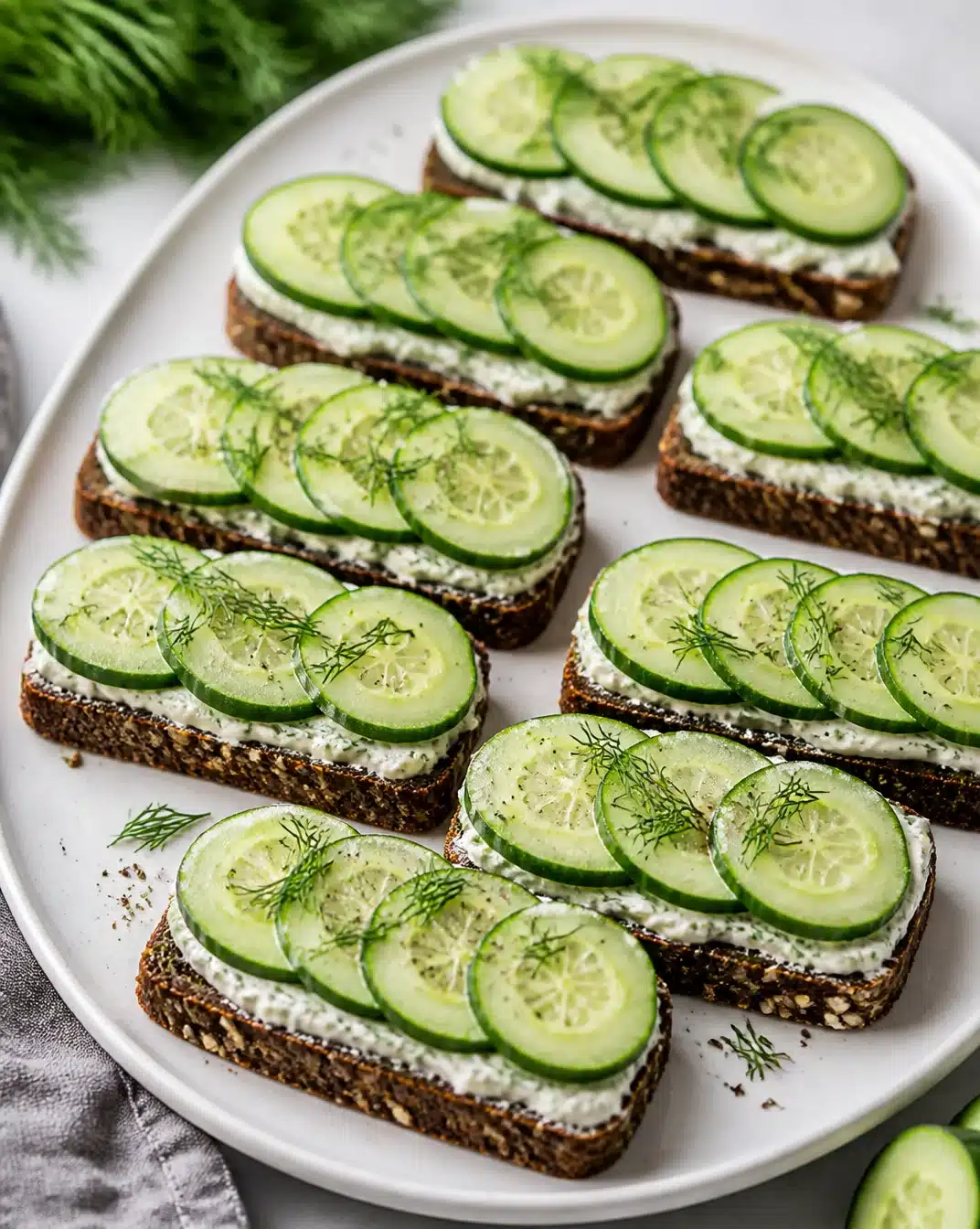 Crisp Cucumber Tea Sandwiches 1 Crisp cucumber tea sandwiches served on a platter for a tea party.