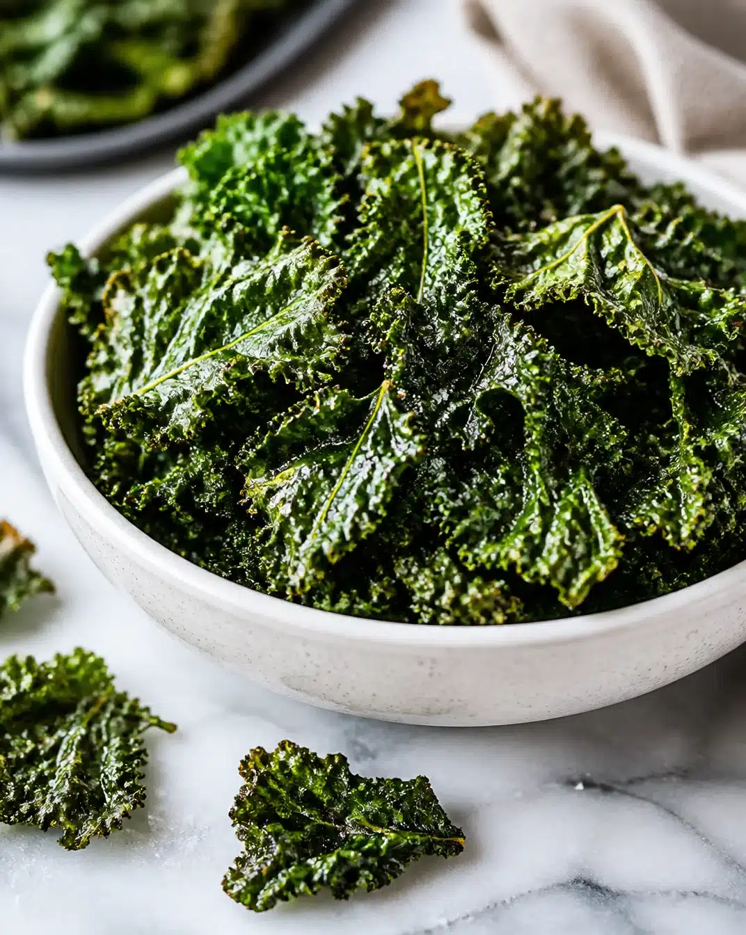 Plate of crispy air fryer kale chips ready to enjoy as a healthy snack.