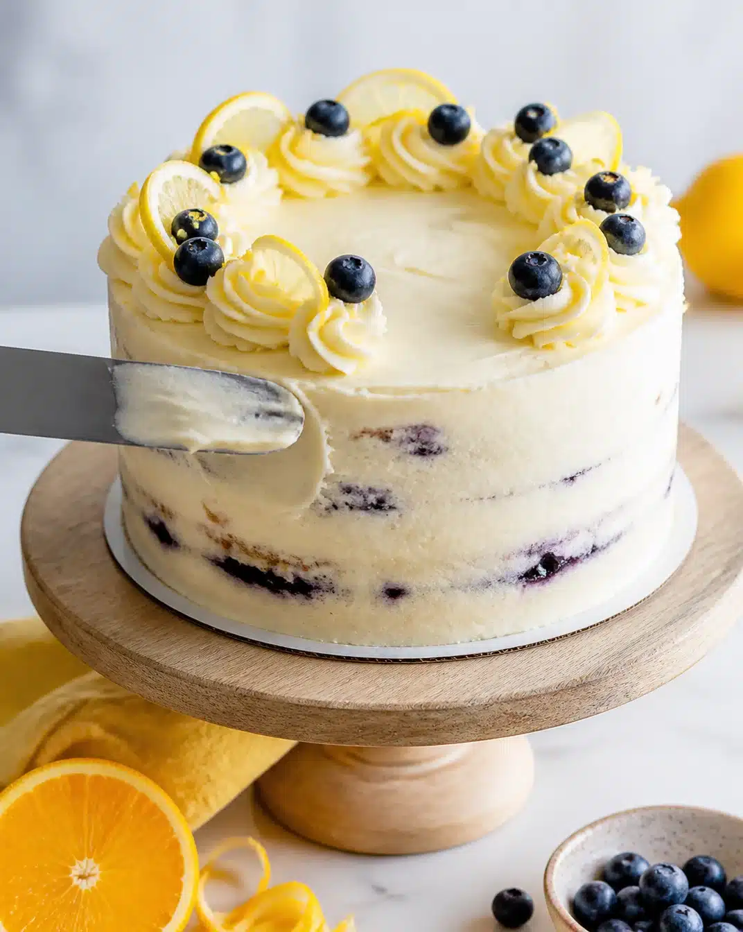 Lemon Blueberry Cake topped with fresh blueberries and lemon zest.