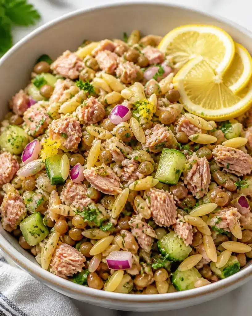 Lemon-infused tuna salad with lentils and orzo served in a bowl