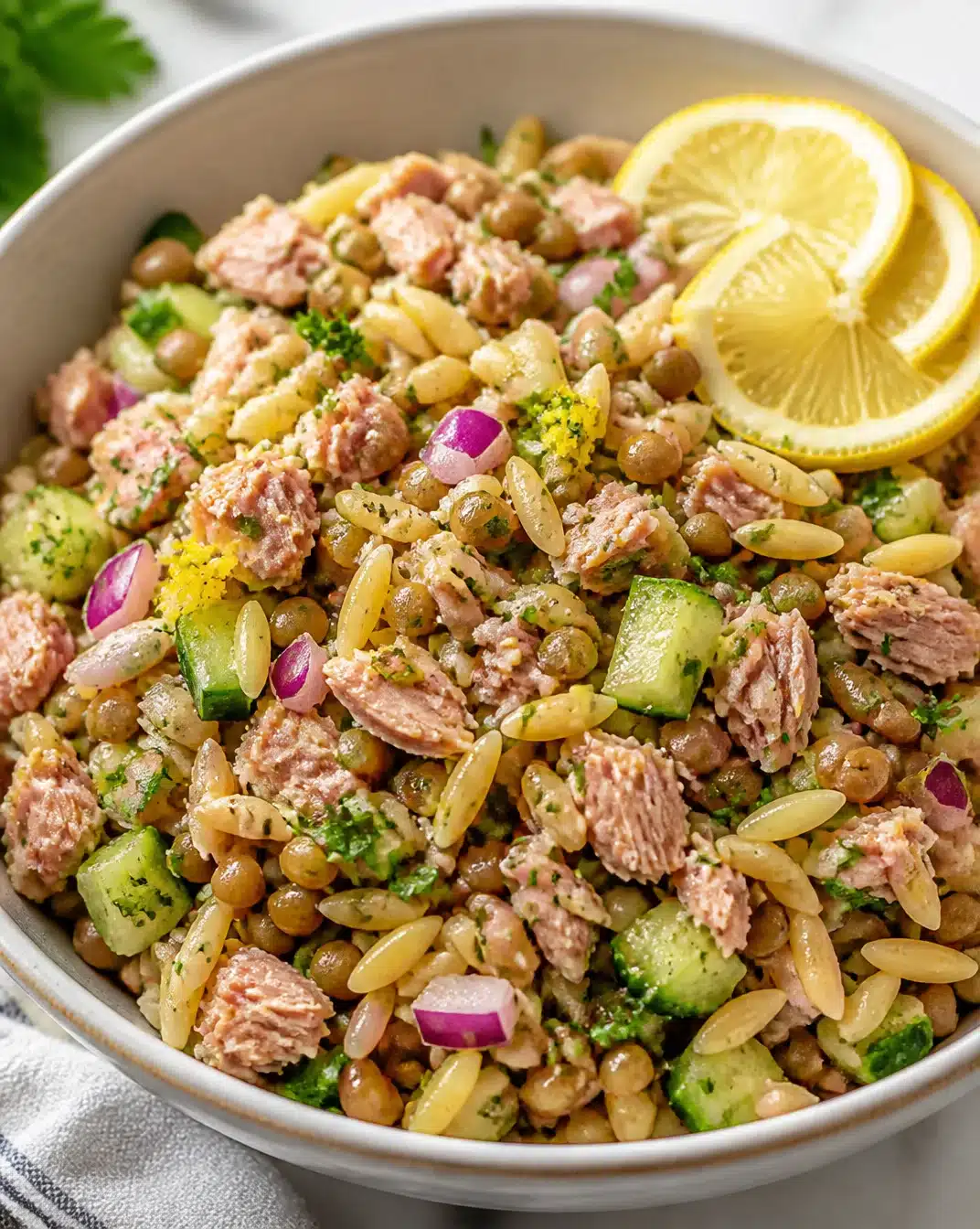 Lemon-infused tuna salad with lentils and orzo served in a bowl