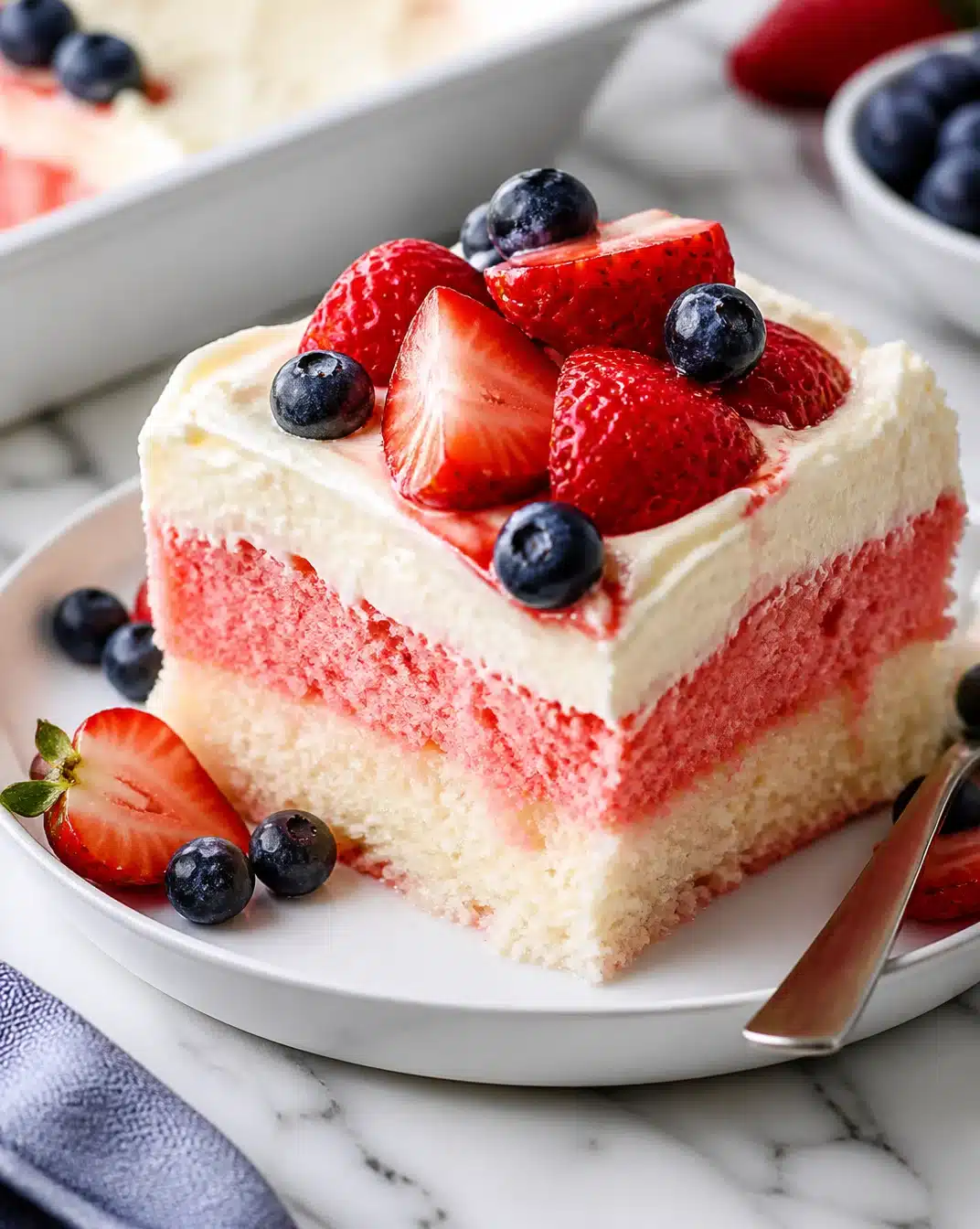 Patriotic Flag Cake topped with cheesecake, perfect for celebrations and holidays.