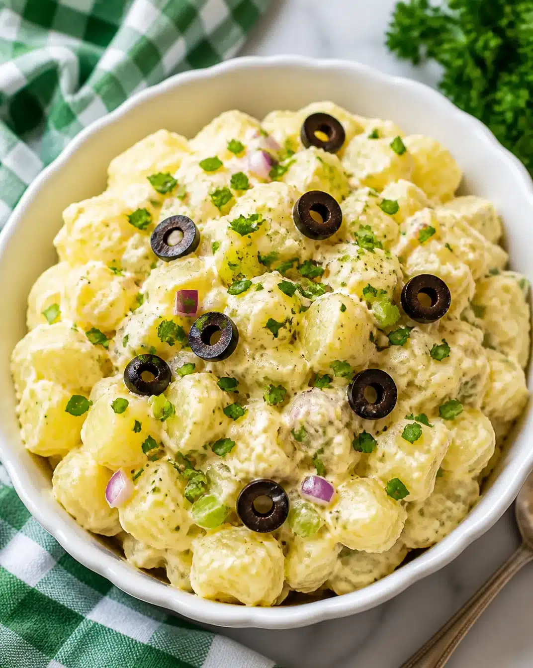 Delicious homemade potato salad in a bowl, garnished with herbs.
