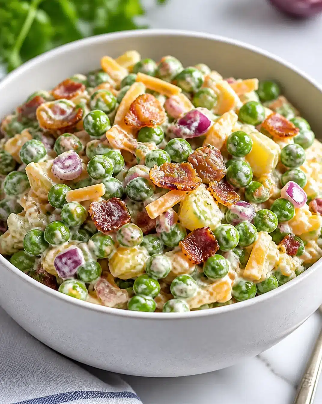 Traditional English Pea Salad made with fresh peas, herbs, and dressing